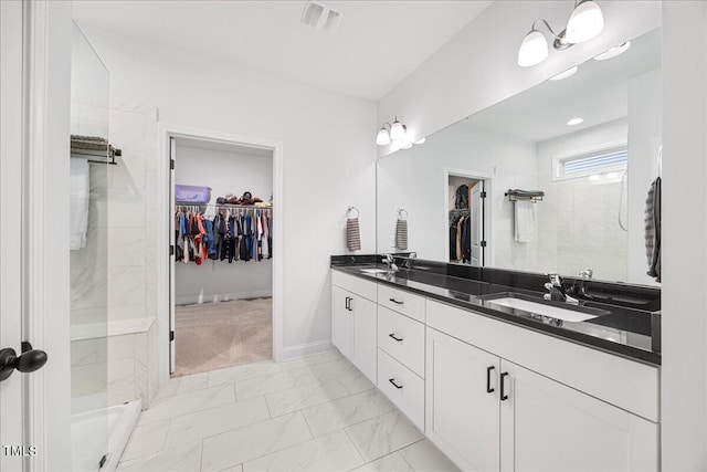247 Axis Deer Ln, Garner, NC 27529 - bathroom featuring a walk in closet, marble finish floors, double vanity, and a tile shower