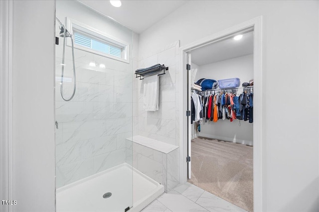 247 Axis Deer Ln, Garner, NC 27529 - bathroom with tiled shower, marble look tile flooring, and a walk in closet