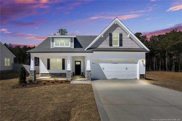 91 Laramie Ln, Selma, NC 27576 - view of front of property with a porch, stone siding, driveway, a garage, and a shingled roof