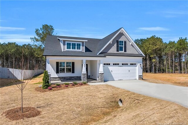 91 Laramie Ln, Selma, NC 27576 - craftsman house with driveway, covered porch, stone siding, and a shingled roof