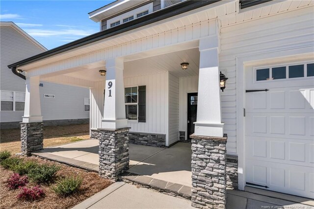 91 Laramie Ln, Selma, NC 27576 - property entrance featuring a porch and stone siding
