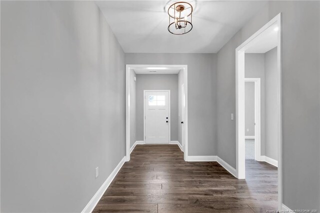 91 Laramie Ln, Selma, NC 27576 - entryway featuring dark wood-type flooring, a chandelier, and baseboards
