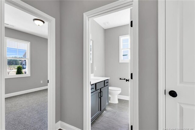 91 Laramie Ln, Selma, NC 27576 - bathroom with baseboards, vanity, toilet, and plenty of natural light