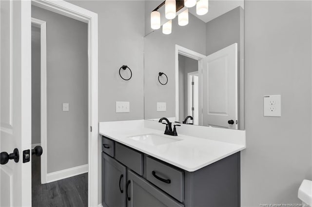 91 Laramie Ln, Selma, NC 27576 - bathroom with a chandelier, vanity, baseboards, wood finished floors, and toilet