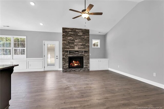91 Laramie Ln, Selma, NC 27576 - unfurnished living room featuring lofted ceiling, a ceiling fan, dark wood-style floors, and a stone fireplace