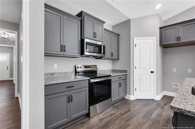 91 Laramie Ln, Selma, NC 27576 - kitchen with appliances with stainless steel finishes, gray cabinetry, dark wood finished floors, baseboards, and light stone counters