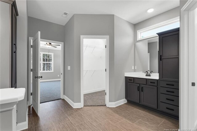 91 Laramie Ln, Selma, NC 27576 - bathroom featuring vanity, ceiling fan, baseboards, and plenty of natural light