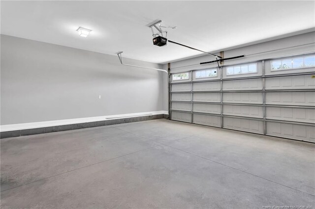 91 Laramie Ln, Selma, NC 27576 - garage with a garage door opener and baseboards