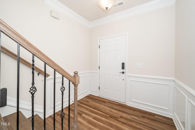 2619 Bordwell Grant Dr, New Hill, NC 27562 - foyer entrance featuring ornamental molding, dark wood-type flooring, wainscoting, and stairway