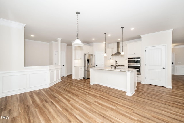2619 Bordwell Grant Dr, New Hill, NC 27562 - kitchen with stainless steel appliances, wall chimney range hood, white cabinets, light wood-type flooring, and decorative backsplash