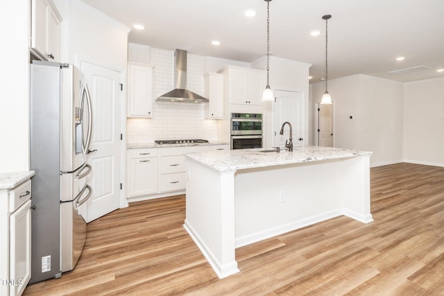 2619 Bordwell Grant Dr, New Hill, NC 27562 - kitchen with stainless steel appliances, wall chimney exhaust hood, a sink, tasteful backsplash, and light wood-style floors
