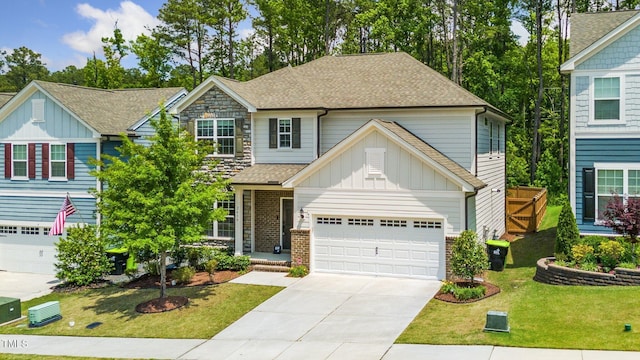 2619 Bordwell Grant Dr, New Hill, NC 27562 - view of front of home featuring board and batten siding, concrete driveway, roof with shingles, and a front lawn