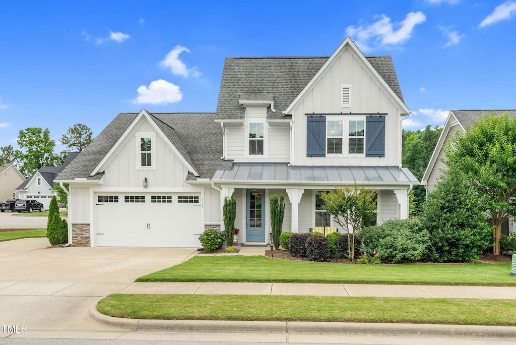 1124 Cedar Farm Trl, Fuquay Varina, NC 27526 - view of front of house with board and batten siding, a shingled roof, concrete driveway, and a garage