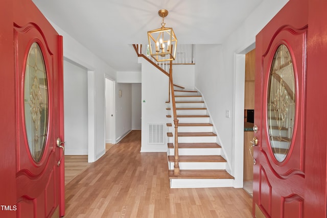 307 Country Club Dr, Durham, NC 27712 - foyer entrance featuring light wood-style flooring, stairway, a chandelier, and baseboards