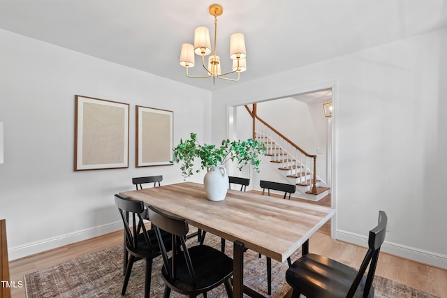 307 Country Club Dr, Durham, NC 27712 - dining space with a chandelier, light wood-type flooring, stairway, and baseboards