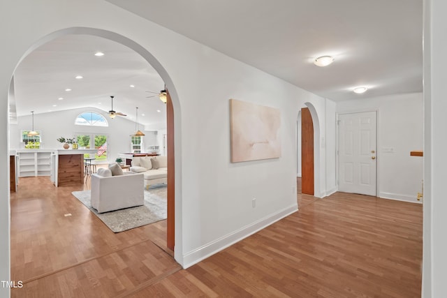 307 Country Club Dr, Durham, NC 27712 - corridor featuring arched walkways, lofted ceiling, light wood-style flooring, and baseboards