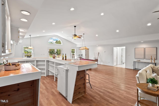 307 Country Club Dr, Durham, NC 27712 - kitchen with a ceiling fan, open floor plan, vaulted ceiling, light wood-style flooring, and a kitchen breakfast bar