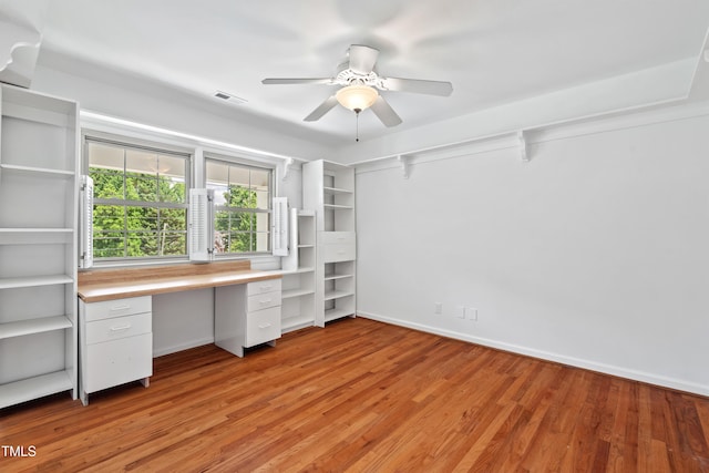 307 Country Club Dr, Durham, NC 27712 - unfurnished office with ceiling fan, built in desk, light wood-style floors, and baseboards