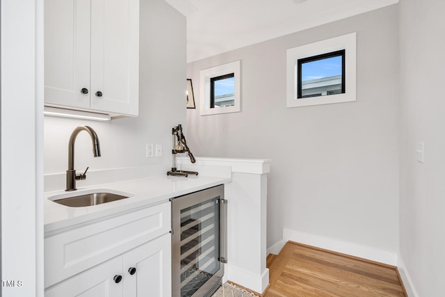 606 Velma Hopkins Ln, Raleigh, NC 27603 - indoor wet bar featuring beverage cooler, light wood-style floors, and baseboards