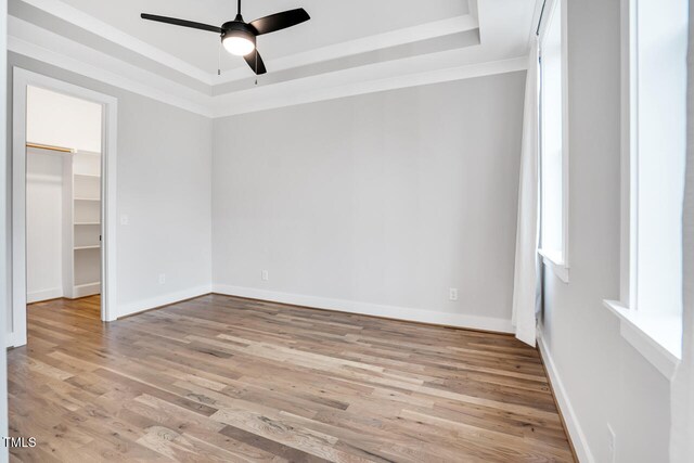606 Velma Hopkins Ln, Raleigh, NC 27603 - spare room with a raised ceiling, ceiling fan, wood finished floors, and baseboards