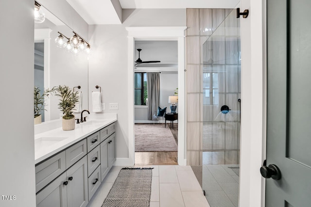 606 Velma Hopkins Ln, Raleigh, NC 27603 - full bath with double vanity, ceiling fan, tiled shower, baseboards, and ensuite bathroom