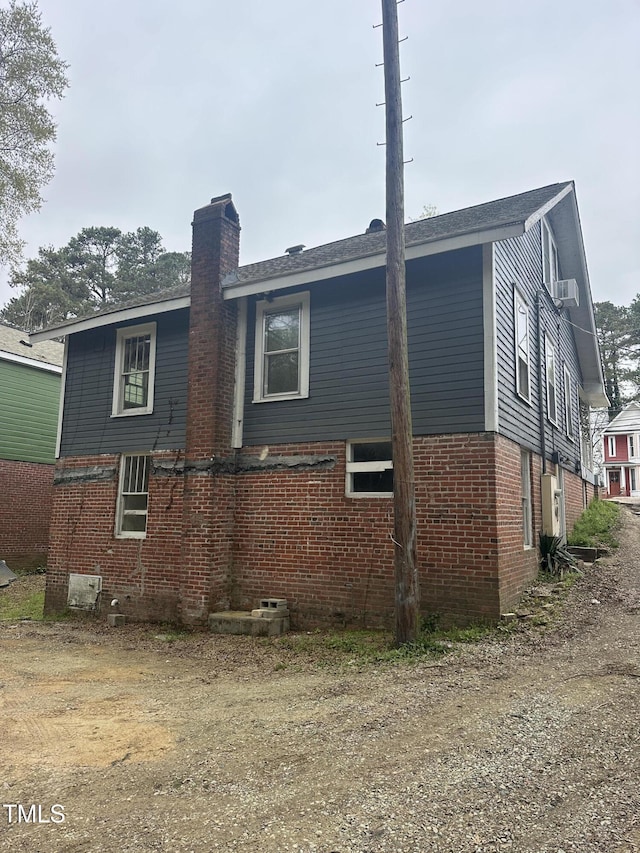 2503 Chapel Hill Rd, Durham, NC 27707 - view of side of property with a chimney, brick siding, and cooling unit