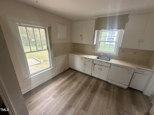 2503 Chapel Hill Rd, Durham, NC 27707 - kitchen featuring a sink, white dishwasher, wood finished floors, light countertops, and white cabinets