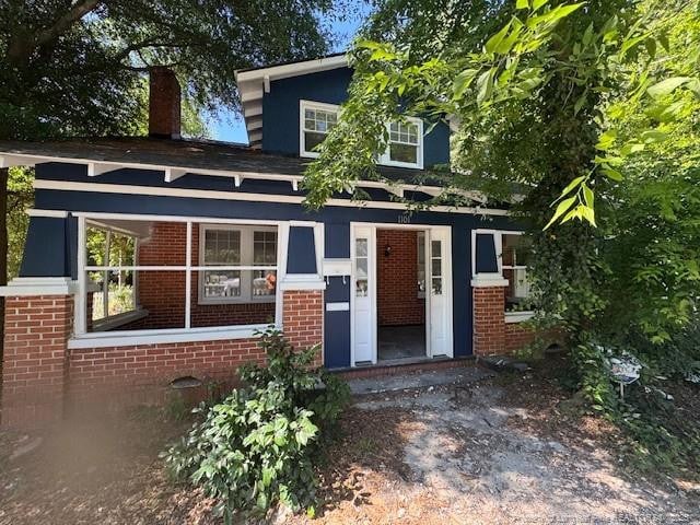 1101 Branson St, Fayetteville, NC 28305 - view of front of home featuring brick siding and a chimney