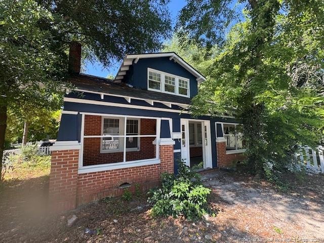 1101 Branson St, Fayetteville, NC 28305 - view of front of property with brick siding and a chimney
