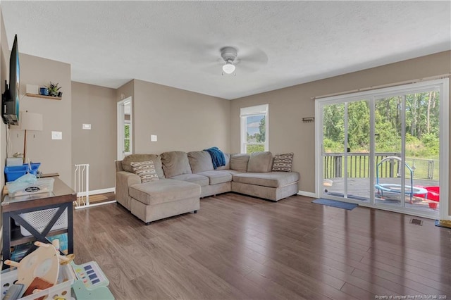 2251 Hackney Loop, Fayetteville, NC 28304 - living room featuring ceiling fan, wood finished floors, baseboards, and a textured ceiling
