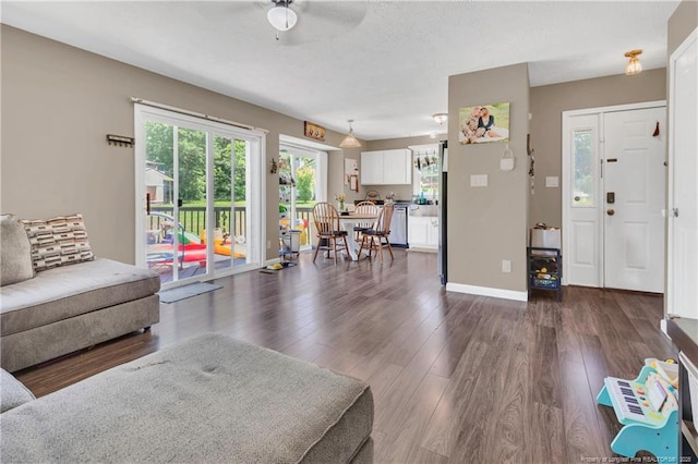 2251 Hackney Loop, Fayetteville, NC 28304 - living area with ceiling fan, dark wood-style floors, and baseboards