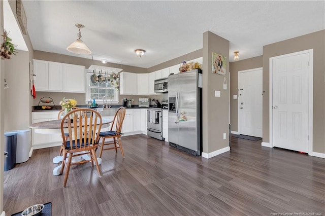 2251 Hackney Loop, Fayetteville, NC 28304 - kitchen featuring appliances with stainless steel finishes, white cabinets, and dark wood-type flooring