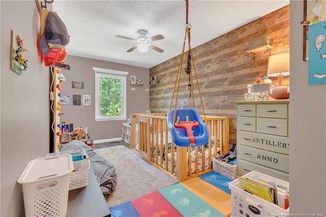 2251 Hackney Loop, Fayetteville, NC 28304 - game room featuring wooden walls, a ceiling fan, and an accent wall