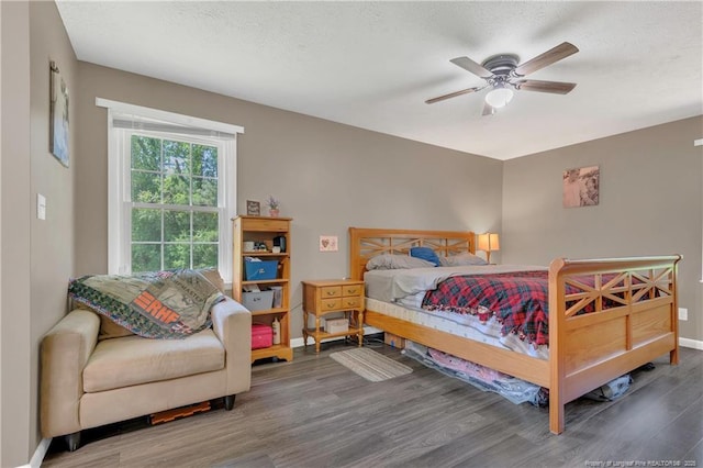 2251 Hackney Loop, Fayetteville, NC 28304 - bedroom featuring wood finished floors, baseboards, a ceiling fan, and a textured ceiling