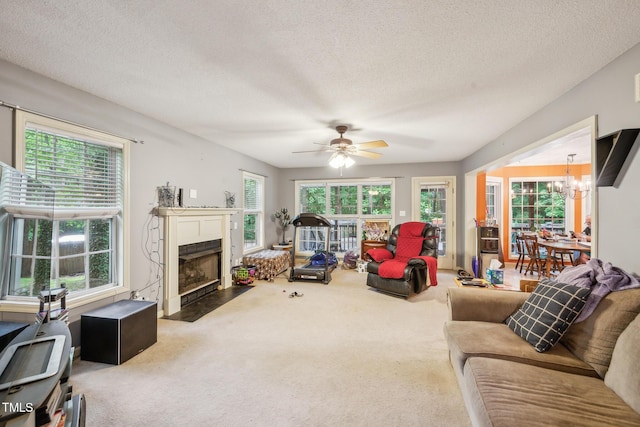 115 Redbay Ln, Clayton, NC 27527 - living area featuring carpet flooring, a chandelier, a textured ceiling, a fireplace with flush hearth, and a ceiling fan