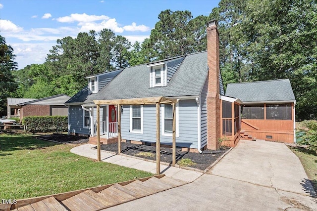 111 Mcdole Cir, Cary, NC 27511 - view of front of home with a sunroom, a chimney, concrete driveway, a front lawn, and a shingled roof