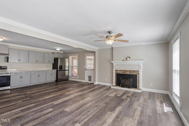 111 Mcdole Cir, Cary, NC 27511 - unfurnished living room featuring dark wood-style floors, a ceiling fan, plenty of natural light, baseboards, and ornamental molding