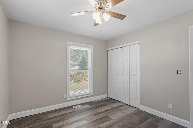111 Mcdole Cir, Cary, NC 27511 - unfurnished bedroom featuring dark wood-type flooring, baseboards, a closet, and a ceiling fan