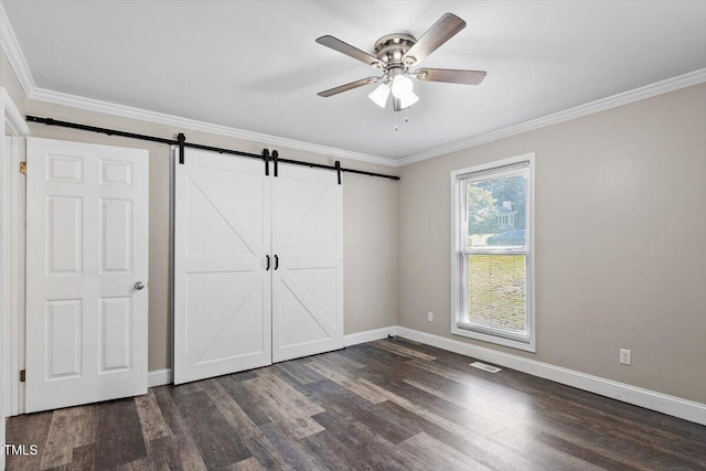 111 Mcdole Cir, Cary, NC 27511 - unfurnished bedroom featuring dark wood-style floors, baseboards, crown molding, a barn door, and a ceiling fan
