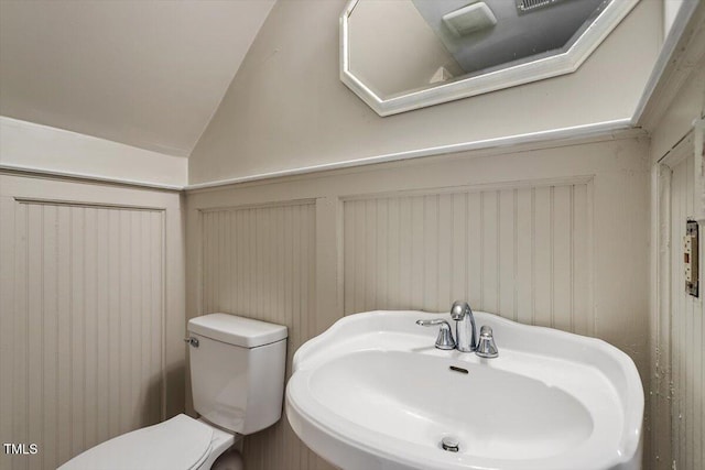 111 Mcdole Cir, Cary, NC 27511 - bathroom featuring a sink, toilet, lofted ceiling, and a decorative wall