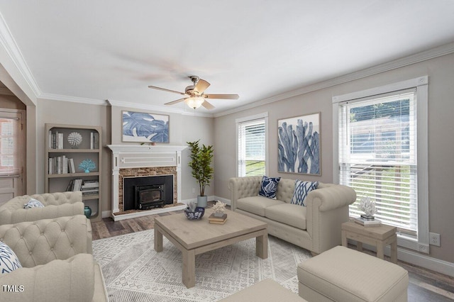 111 Mcdole Cir, Cary, NC 27511 - living area featuring ceiling fan, wood finished floors, ornamental molding, baseboards, and a wood stove
