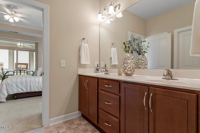 228 Ellisview Dr, Cary, NC 27519 - ensuite bathroom featuring double vanity, baseboards, a chandelier, a ceiling fan, and crown molding