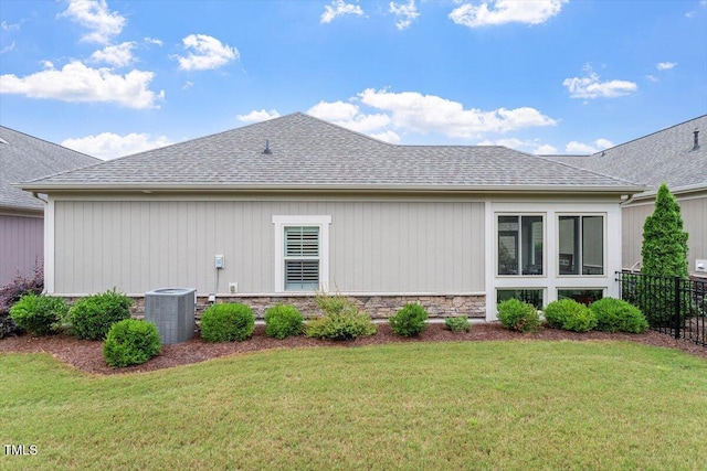 228 Ellisview Dr, Cary, NC 27519 - view of property exterior featuring central AC unit, stone siding, and roof with shingles