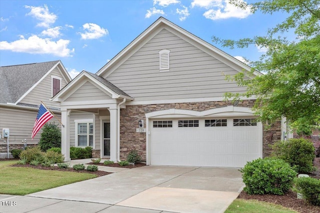 228 Ellisview Dr, Cary, NC 27519 - view of front of property with stone siding, driveway, and a garage