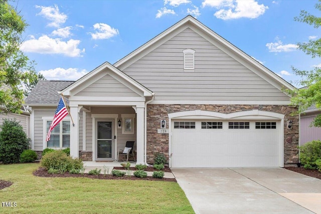 228 Ellisview Dr, Cary, NC 27519 - view of front of house with stone siding, a front yard, a garage, and driveway