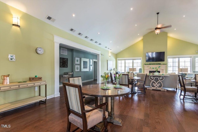 228 Ellisview Dr, Cary, NC 27519 - dining space featuring ceiling fan, a fireplace, wood finished floors, high vaulted ceiling, and plenty of natural light