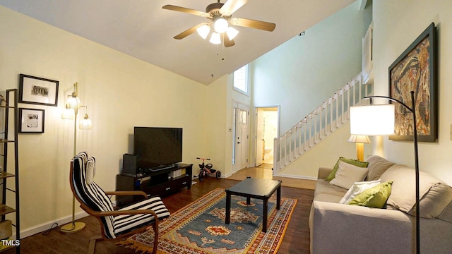 516 Ryan Rd, Cary, NC 27511 - living room with stairway, ceiling fan, wood finished floors, baseboards, and a high ceiling