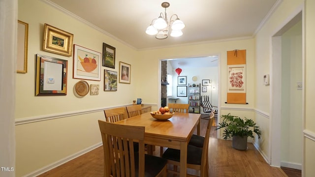 516 Ryan Rd, Cary, NC 27511 - dining space with a chandelier, wood finished floors, crown molding, and baseboards