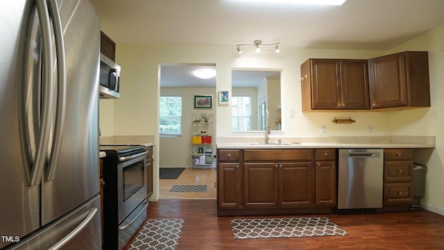516 Ryan Rd, Cary, NC 27511 - kitchen with stainless steel appliances, a sink, dark wood-type flooring, light countertops, and baseboards