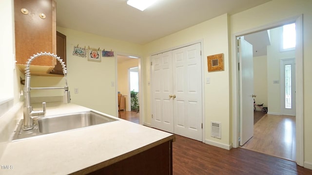 516 Ryan Rd, Cary, NC 27511 - kitchen with a sink, dark wood-style flooring, light countertops, and baseboards